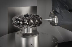 An automated 5-axis CNC machining cell with robotic part handling and AI monitoring systems.